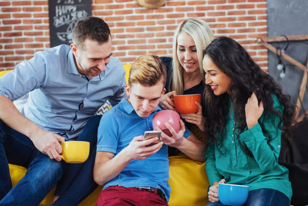 Coworkers looking at a phone